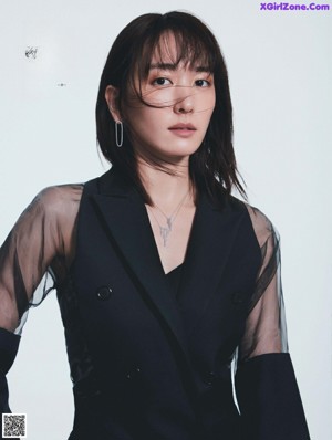 A woman in a white dress posing for a magazine.