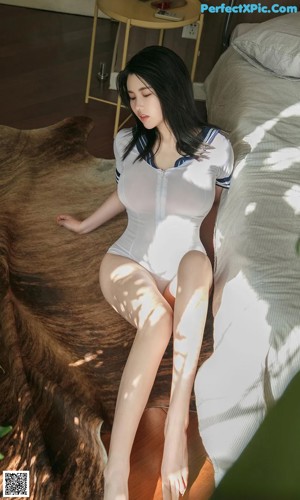 a woman in a sailor outfit sitting on a bed