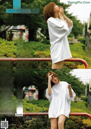 A woman in a white shirt is standing on a railing.