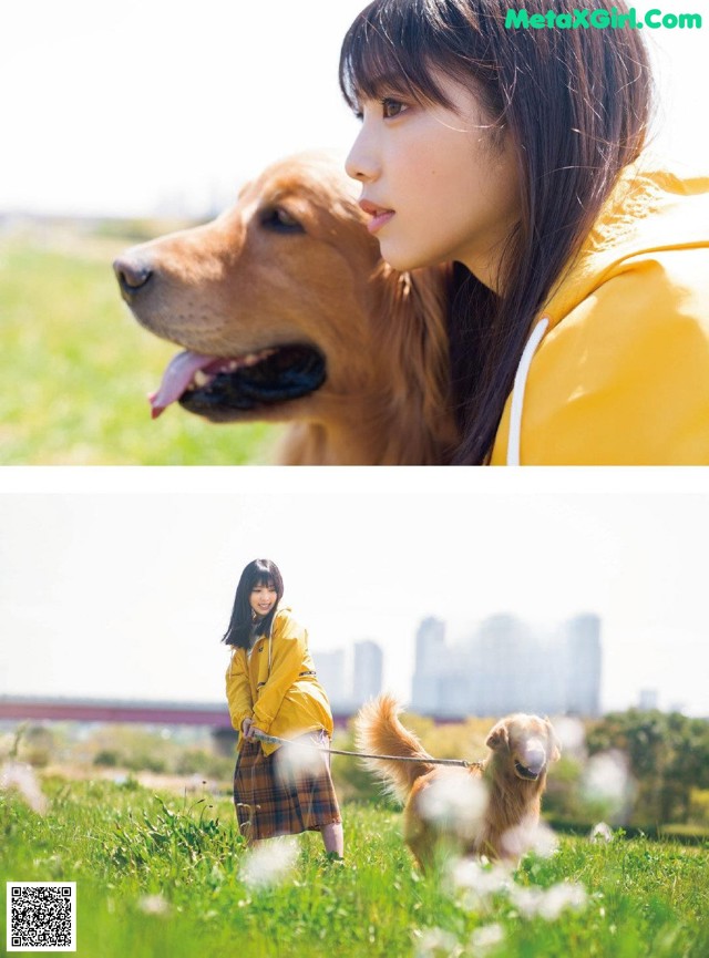 A woman in a yellow raincoat is walking a dog in a field.