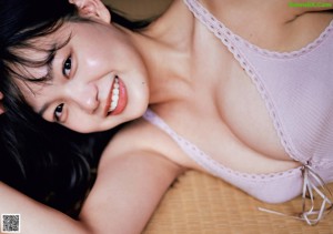 A woman in a white bra and panties posing for a picture.
