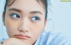 A magazine with a picture of a girl on the cover.