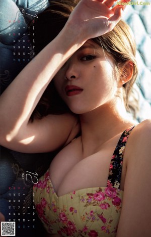 A woman in a denim jumpsuit posing for a calendar.