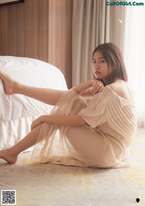 A woman in a white dress posing for a picture.