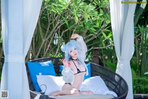 A woman in a bikini standing in a pool.
