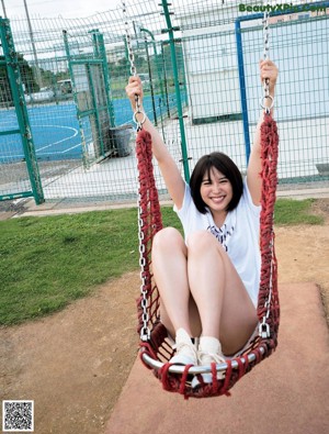 A woman sitting at a table with her legs up on a balcony.