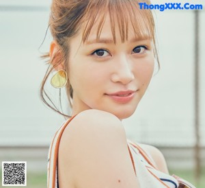 A woman in a white dress is posing for a magazine.