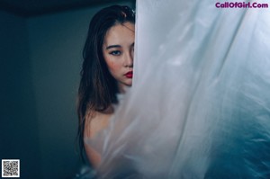 A woman is wrapped up in a plastic bag.