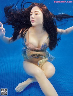 A woman floating in a pool of water. 