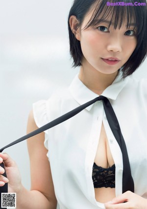 A woman in a black bra and a white shirt.