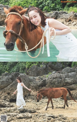 A woman standing in front of a horse in a field.
