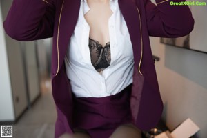 A woman sitting on a chair in a hotel room.