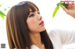 A woman in a white shirt is posing for the camera.