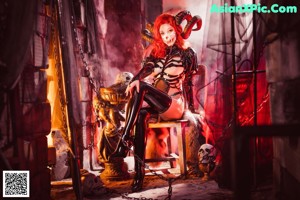 A woman dressed as a skeleton in a dark room.